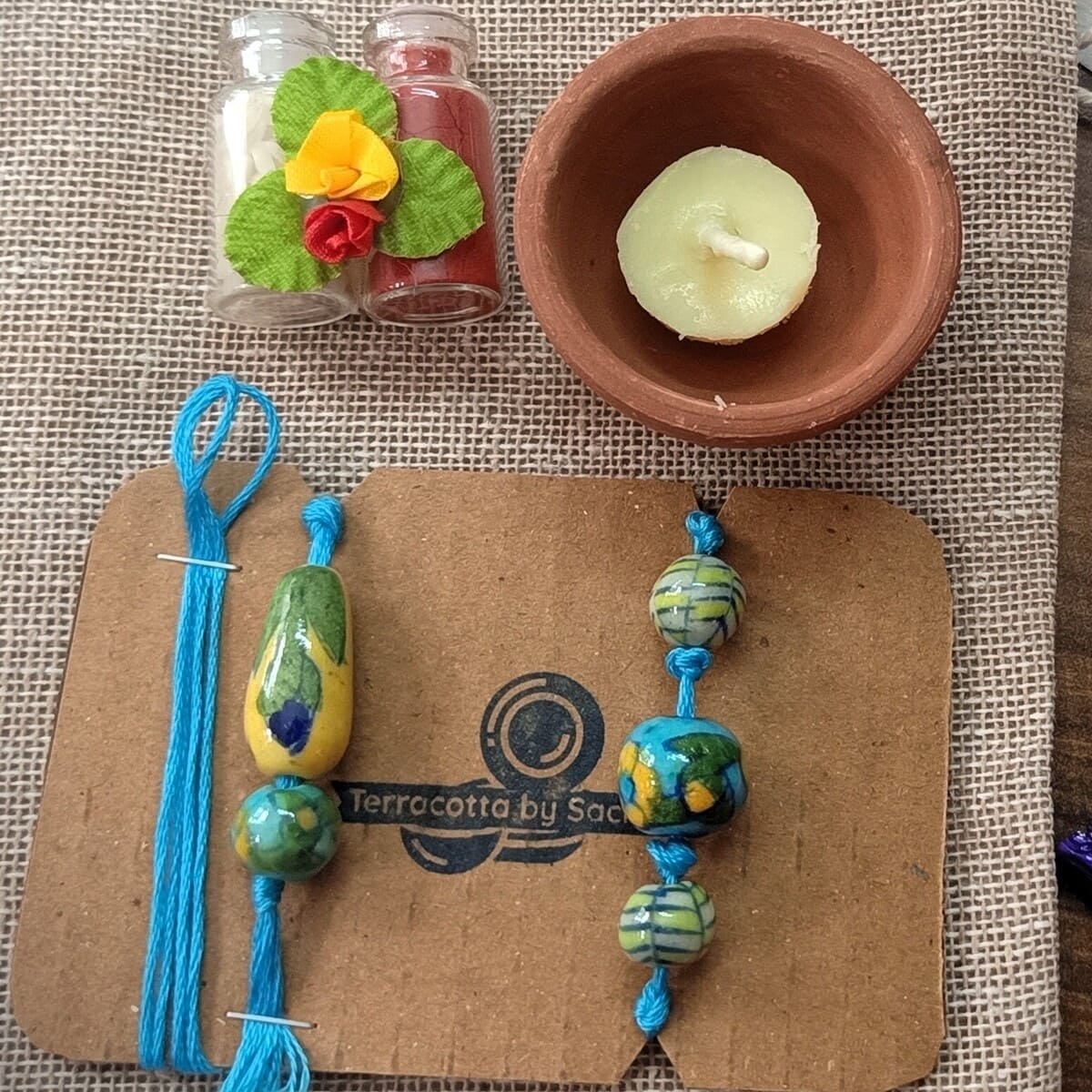 Blue Pottery Bhai - Bhabhi Rakhi +Lumba Festive Hamper – Rakhi by Terracotta by Sachii available on Brown Living™. . SKU: SACHIIRBP002. Img 1.