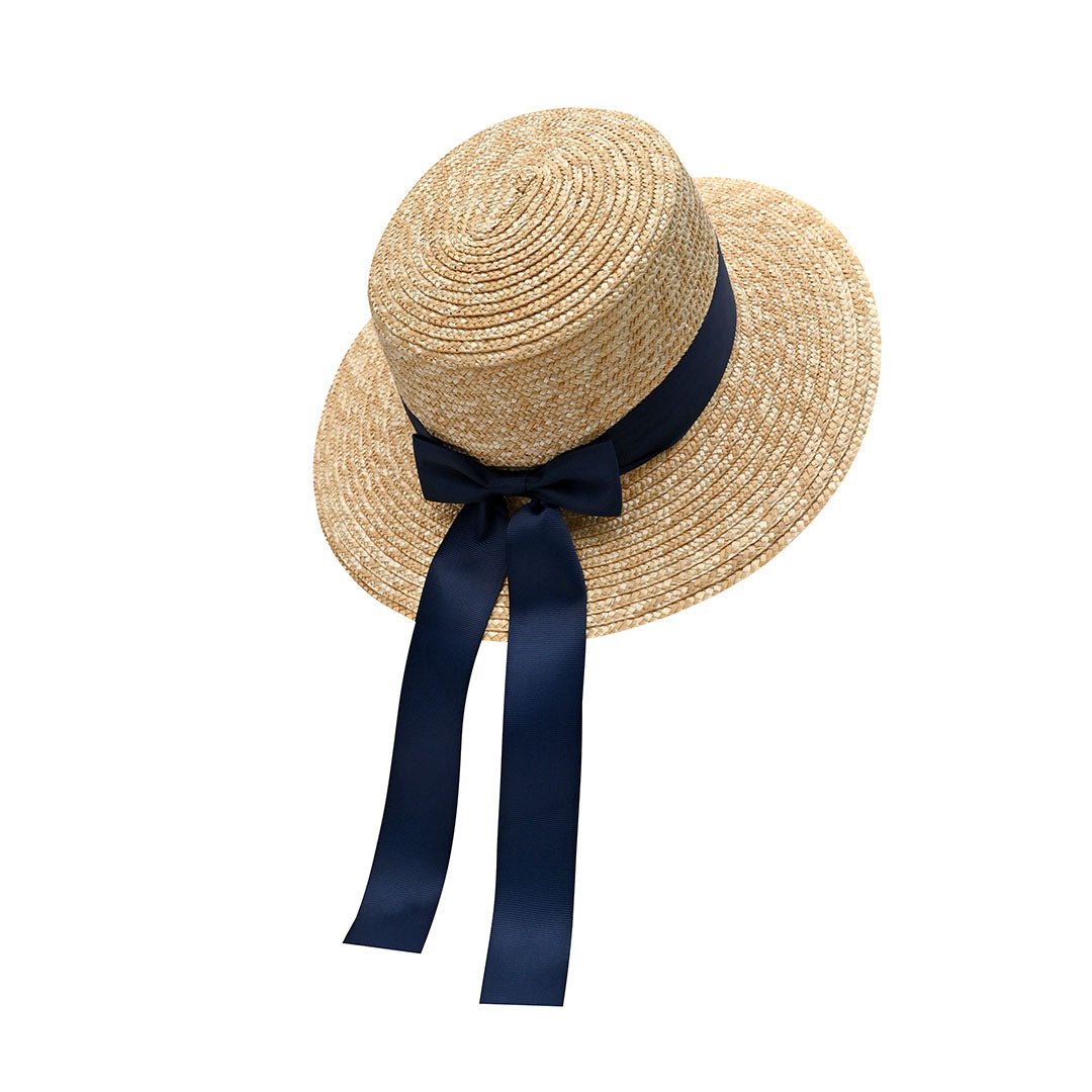 Classic Boater Hat with Navy Blue Ribbon | Timeless Summer Style – Womens Hat on Brown Living™. SKU: MBNL002047. Img 1.