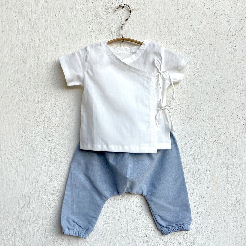 Kids Unisex Organic Cotton Essential White Angrakha Top and Blue Chambray Pants – Kids Daywear Sets on Brown Living™. SKU: WWE - WHTCHM - ANGPYJ - 03 - 0522. Img 1.