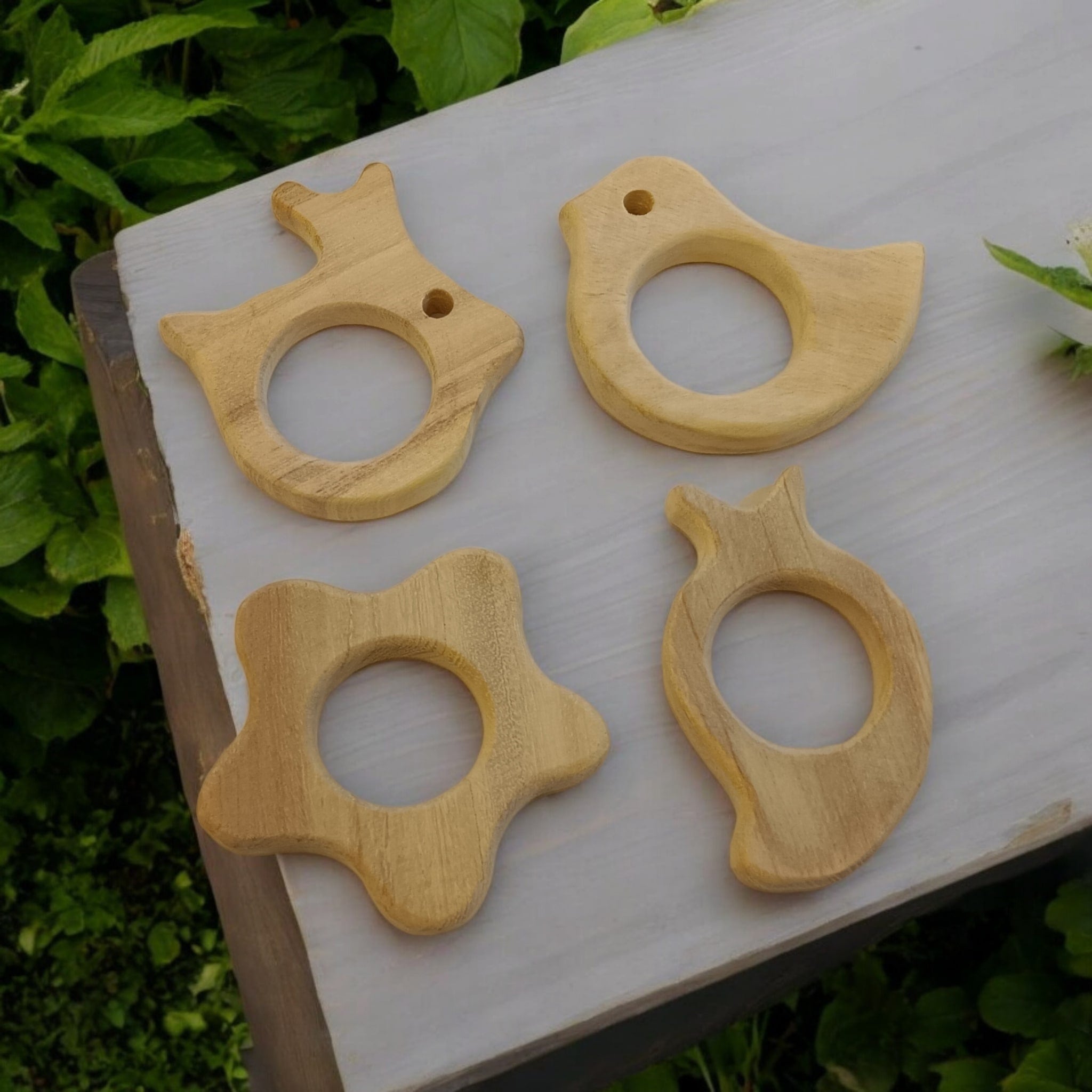 Pack of 4 Neem Wooden Teethers - Rabbit, Flower, Dove & Mango Shapes – Baby Teethers & Soothers on Brown Living™. SKU: T_RBT-FLR-DV-MNG. Img 1.