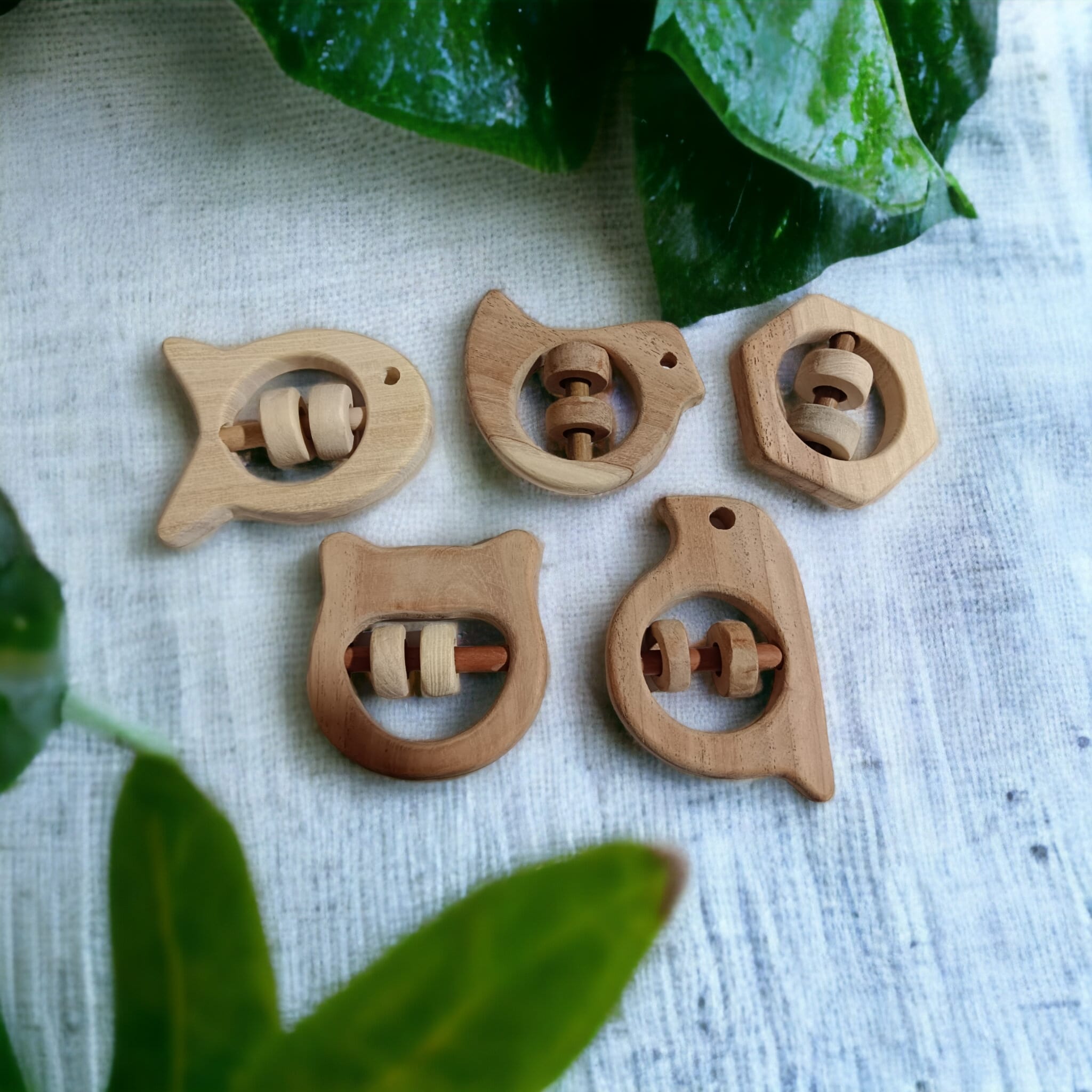 Soundmaking Rattles – Sparrow, Dove, Fish, Hippo & Hexagon Shapes – Baby Rattles on Brown Living™. SKU: R_SET5. Img 1.