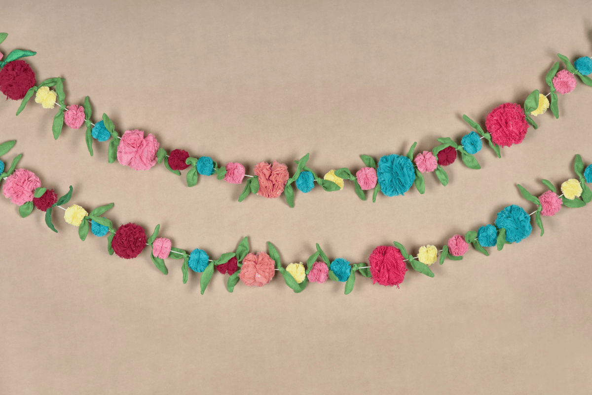 Upcycled Multicolor Flower Decorative Festive Garland String – Wall Decor on Brown Living™. SKU: UMW - FLOWER - STRING - 01. Img 1.