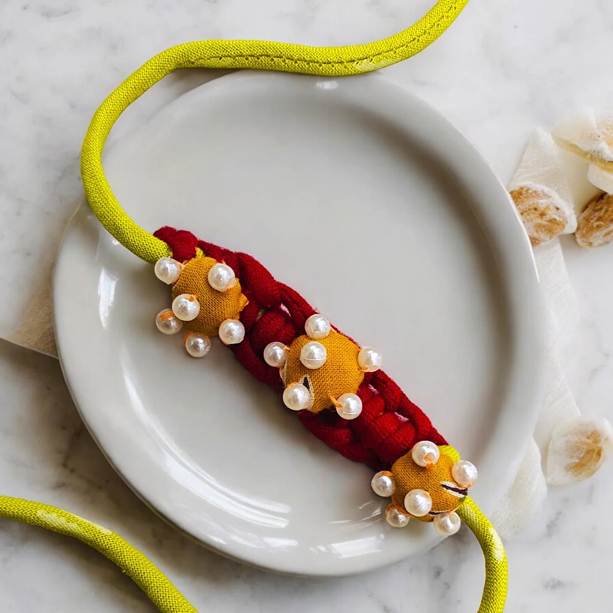 Upcycled Handmade Flower & Bead Rakhi Combo (Pack of 2) – Rakhi by USE ME WORKS available on Brown Living™. . SKU: UMW - Combo - Rakhi - 01. Img 2.