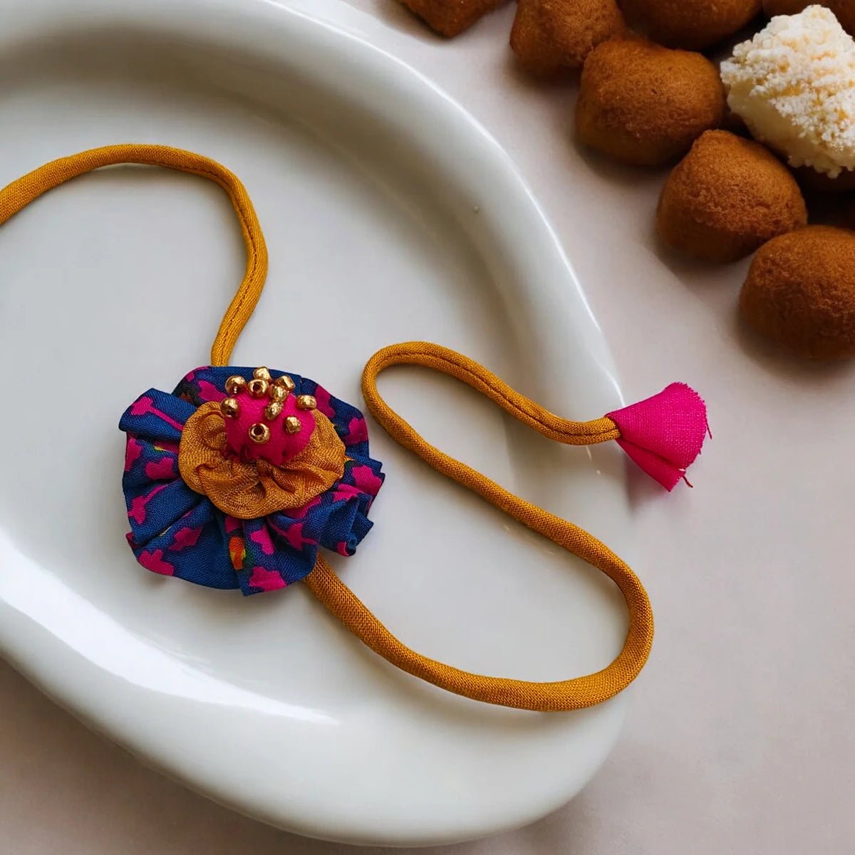 Upcycled Handmade Flower & Bead Rakhi Combo (Pack of 2) – Rakhi by USE ME WORKS available on Brown Living™. . SKU: UMW - Combo - Rakhi - 01. Img 1.