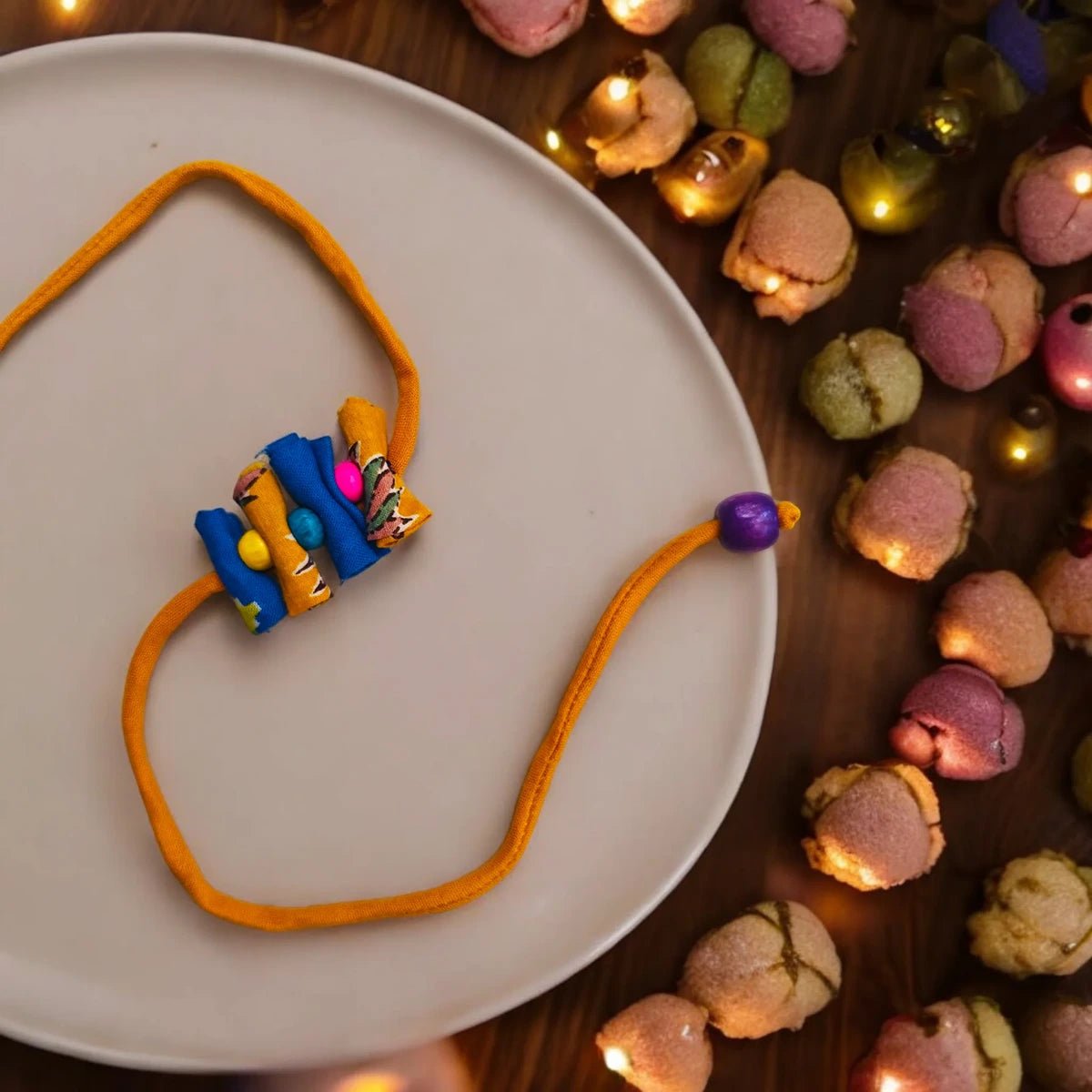 Upcycled Handmade Rolymoly Rakhi – Rakhi by USE ME WORKS available on Brown Living™. . SKU: UMW - Rakhi - 09. Img 1.