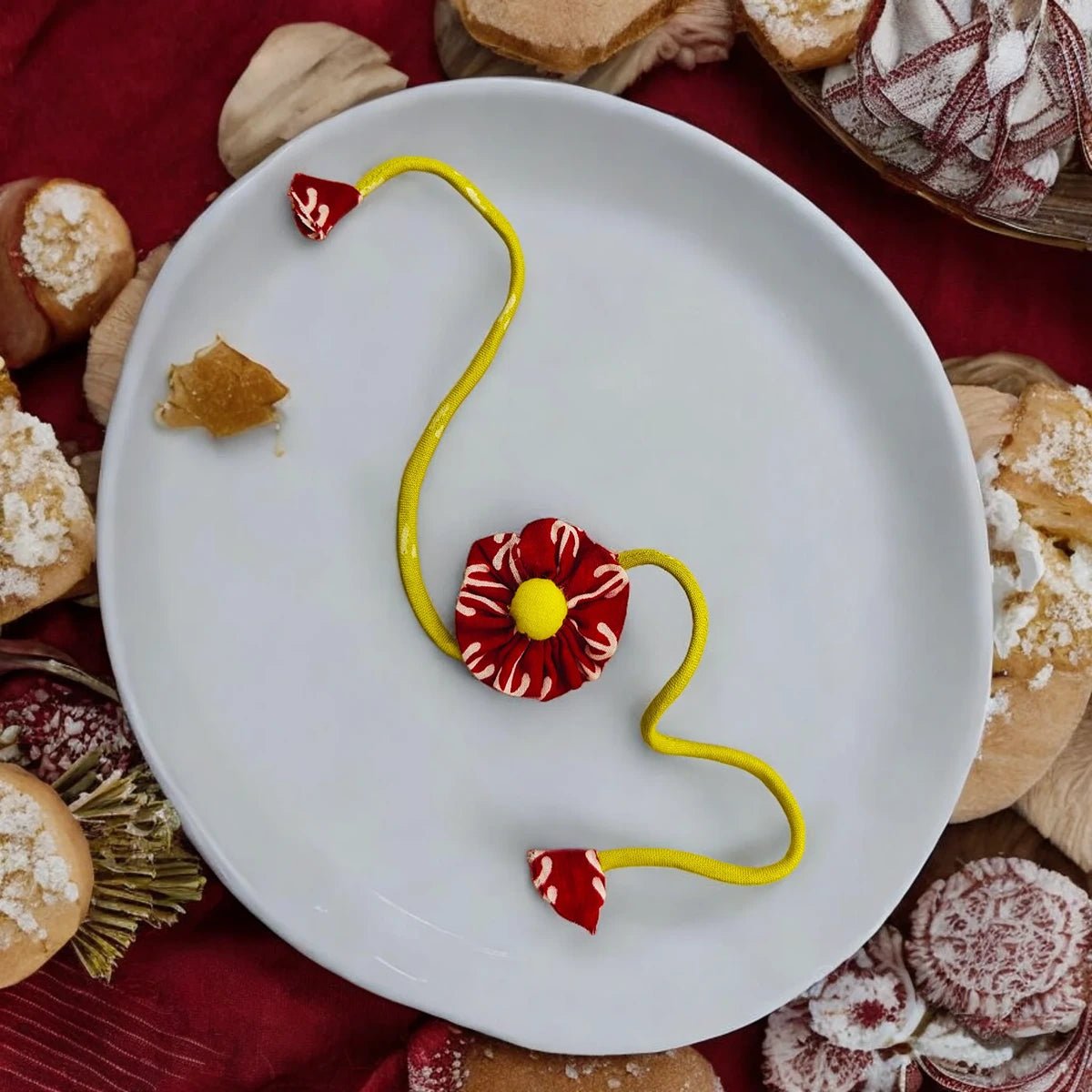 Upcycled Handmade Scarlet Daisy Rakhi – Rakhi by USE ME WORKS available on Brown Living™. . SKU: UMW - Rakhi - 01. Img 1.
