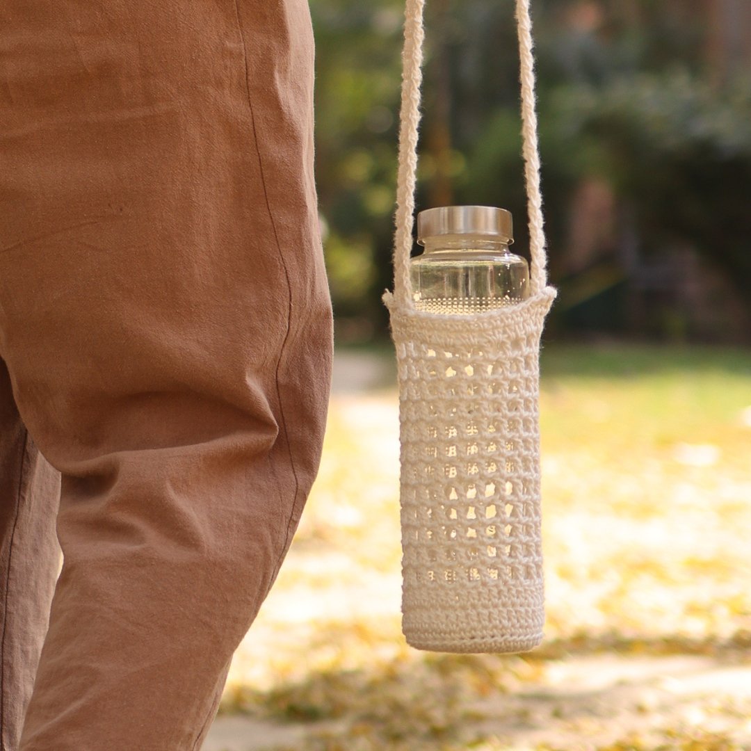 White Handmade Crochet Sling Bottle Cover – Bottles & Sippers by Sarmaya available on Brown Living™. . SKU: SAR109. Img 1.