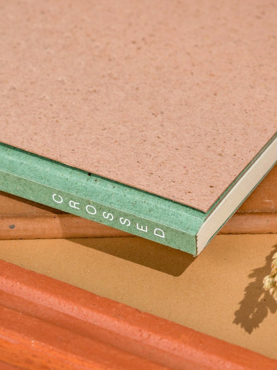 Crossed Gridbook | Perfect bound hard cover, with a built - in envelope pocket at the back | Verified Sustainable by Brown Living™