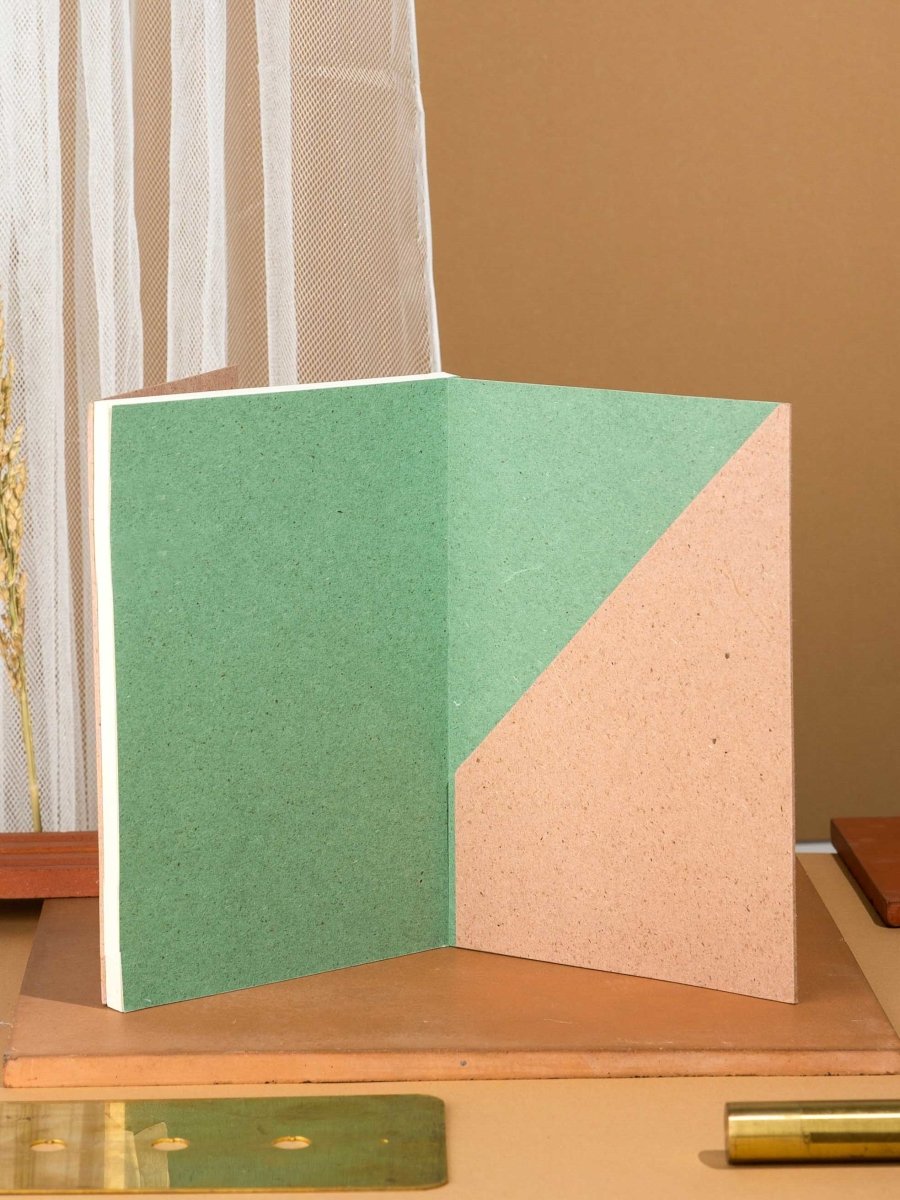 Crossed Gridbook | Perfect bound hard cover, with a built - in envelope pocket at the back | Verified Sustainable by Brown Living™