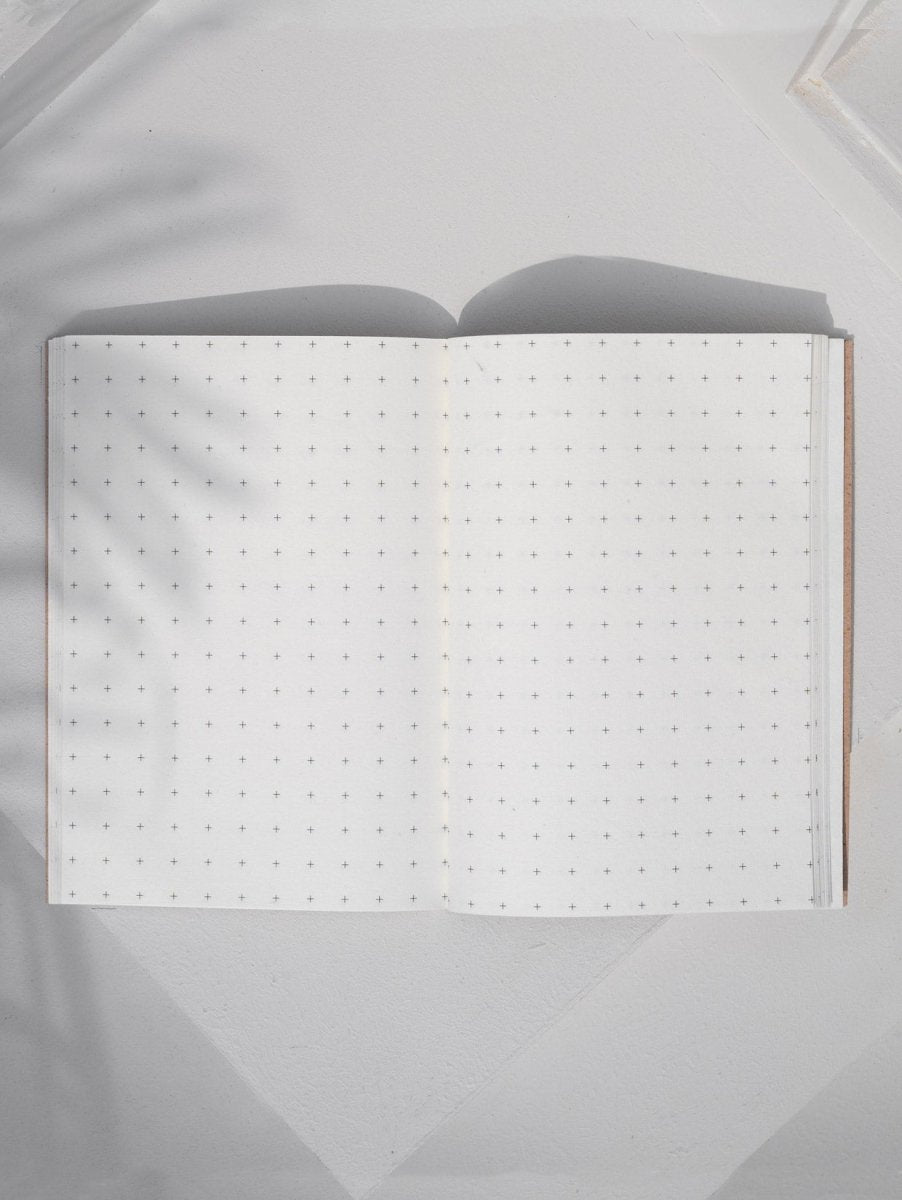 Crossed Gridbook | Perfect bound hard cover, with a built - in envelope pocket at the back | Verified Sustainable by Brown Living™