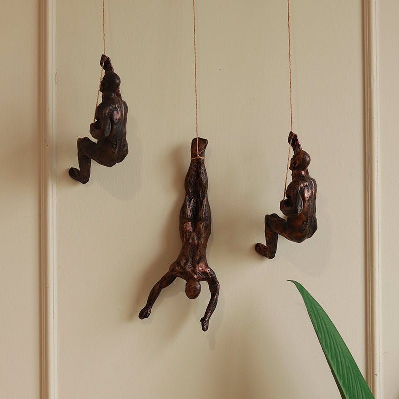 Resin Hanging Man Figurines - Golden – Wall Decor on Brown Living™. SKU: 347514. Img 1.