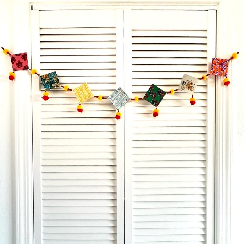 Upcycled Cotton and Newsaper Toran – Wall Decor on Brown Living™. SKU: GRTRN02. Img 1.