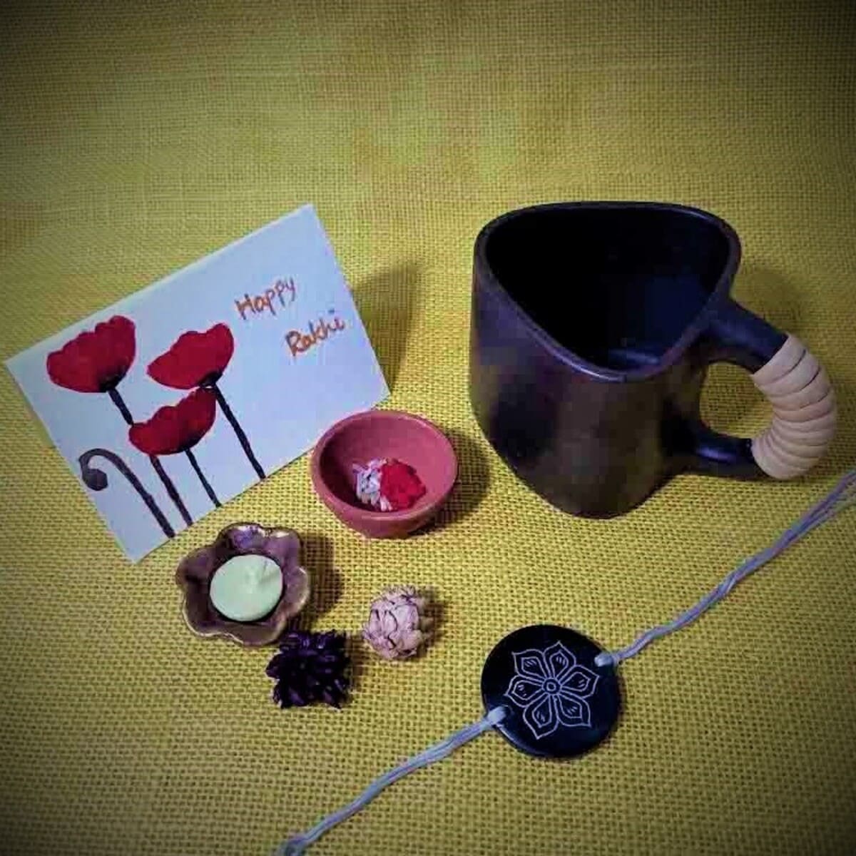 Black Pottery Bhai Rakhi Gift Hamper – Rakhi by Terracotta by Sachii available on Brown Living™. . SKU: SACHIIRN0021. Img 1.