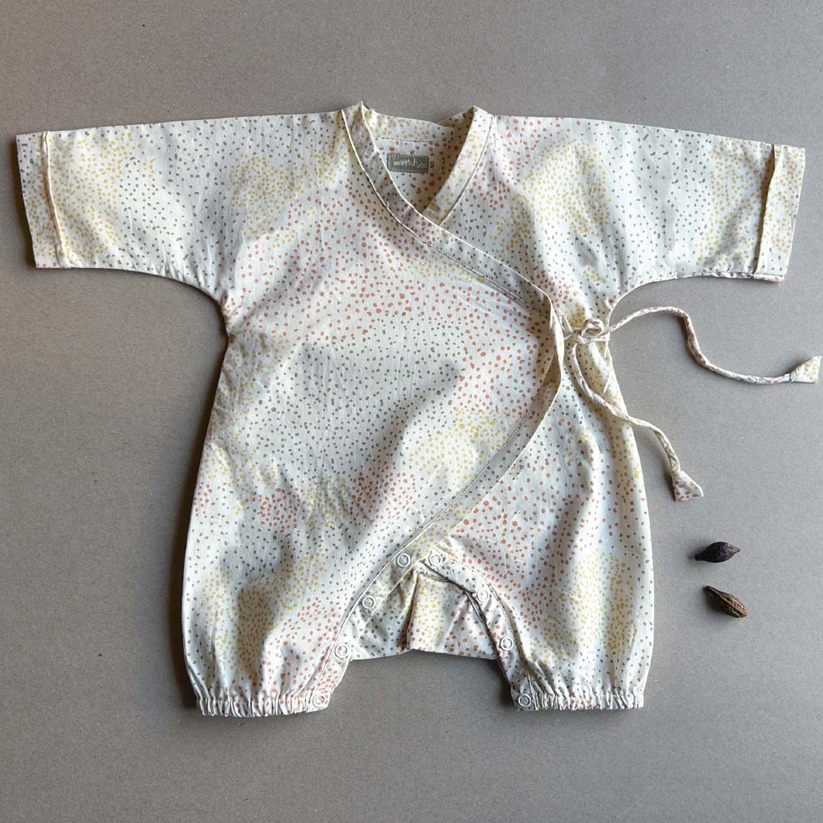 Cosmos Baby Romper – Kids Onesies on Brown Living™. SKU: AGHCOSROMPOPNB. Img 1.