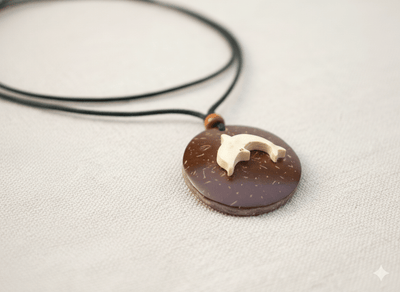 Handcrafted Coconut Shell Dolphin Pendant with Cotton Rope – Womens Charms & Pendants on Brown Living™. SKU: KOTT025. Img 1.