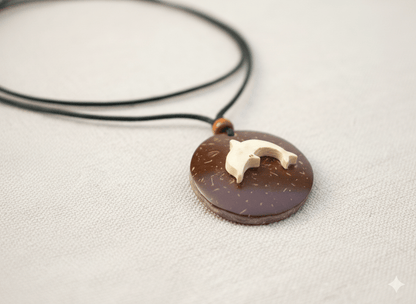 Handcrafted Coconut Shell Dolphin Pendant with Cotton Rope – Womens Charms & Pendants on Brown Living™. SKU: KOTT025. Img 1.
