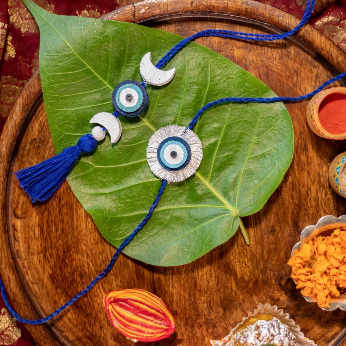 Nazarbattu Rakhi Gift Box | Rakhi and Lumba Set, Bamboo Speaker, Planting Material – Rakhi by Scrapshala available on Brown Living™. . SKU: SSR017. Img 3.