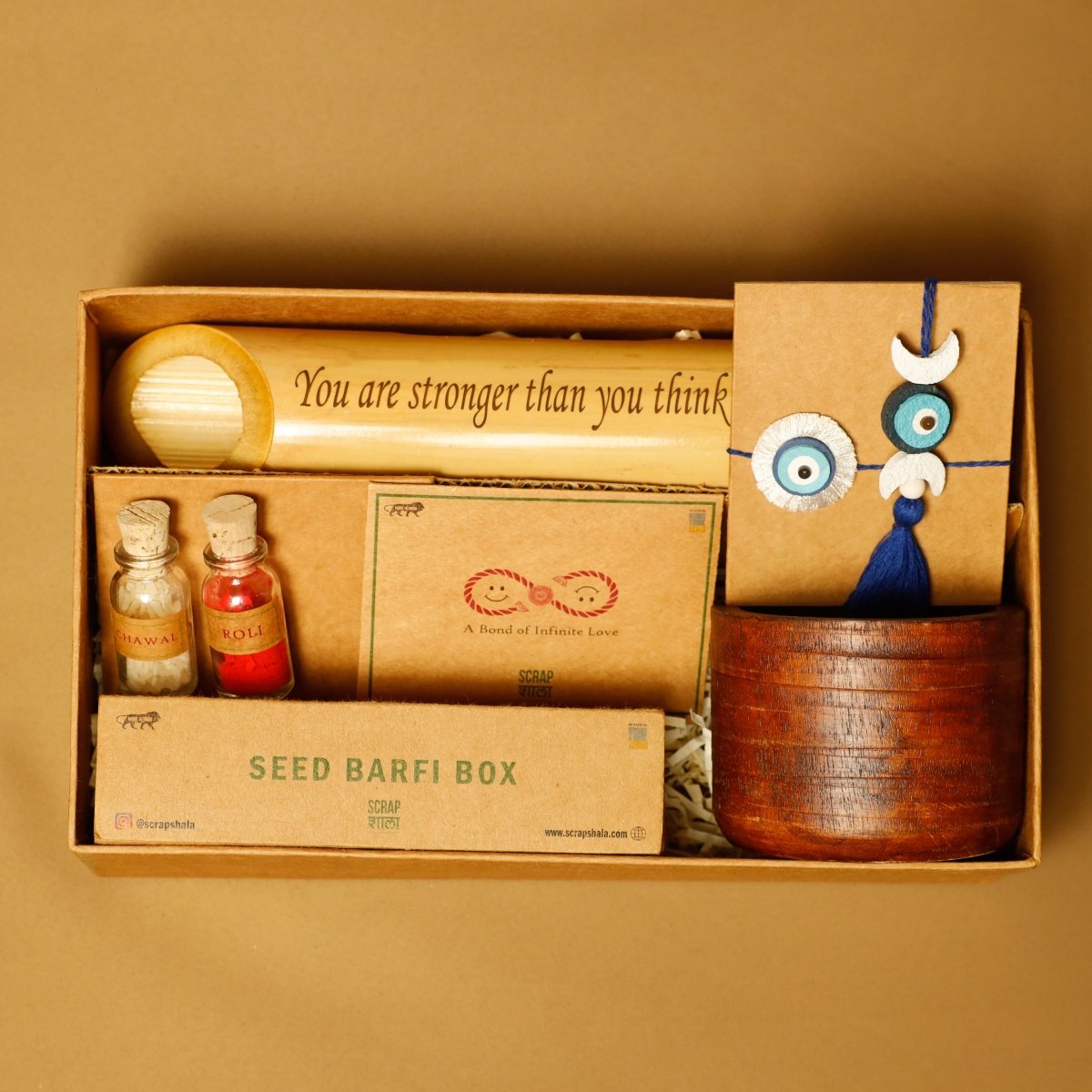 Nazarbattu Rakhi Gift Box | Rakhi and Lumba Set, Bamboo Speaker, Planting Material – Rakhi by Scrapshala available on Brown Living™. . SKU: SSR017. Img 1.