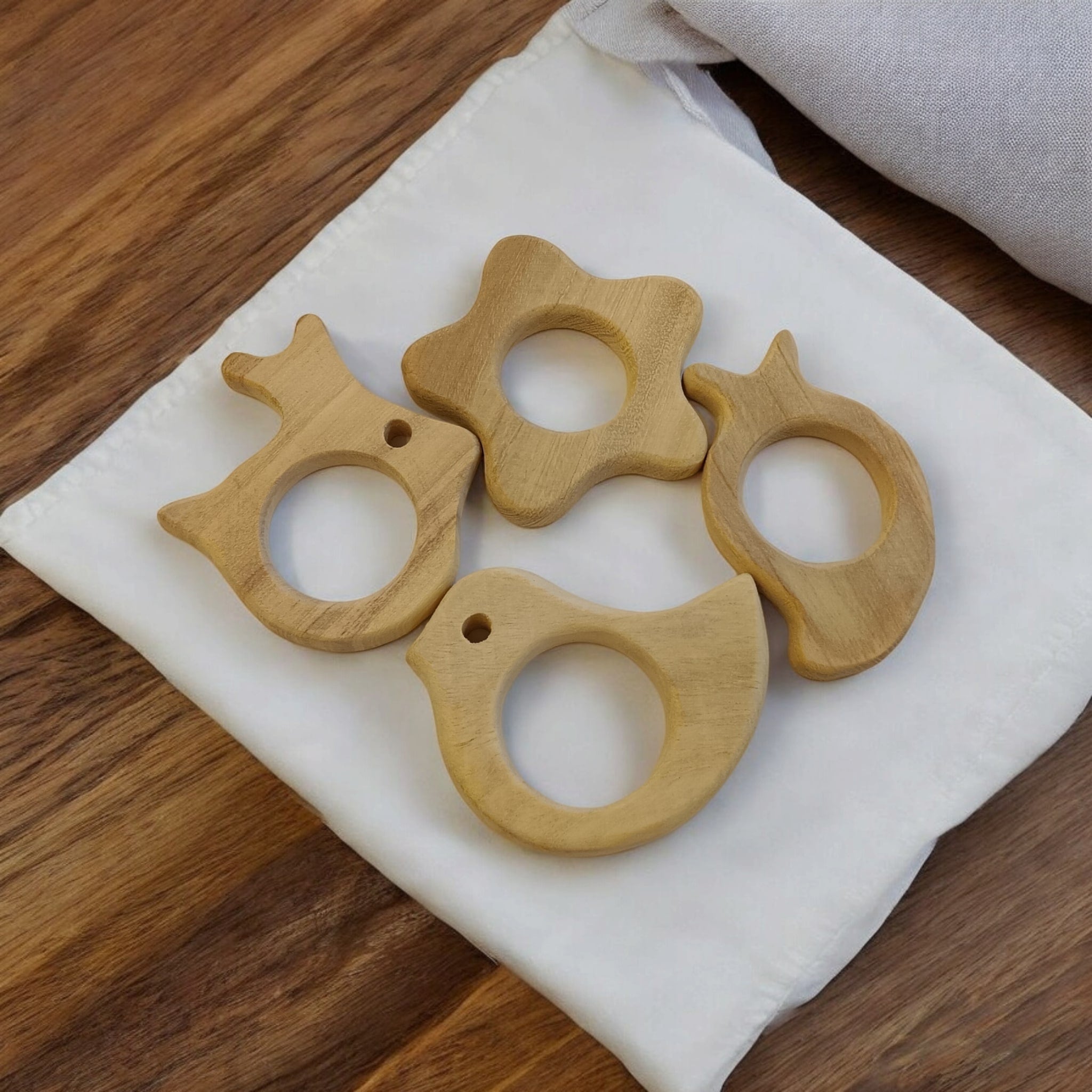 Pack of 4 Neem Wooden Teethers - Rabbit, Flower, Dove & Mango Shapes – Baby Teethers & Soothers on Brown Living™. SKU: T_RBT-FLR-DV-MNG. Img 2.