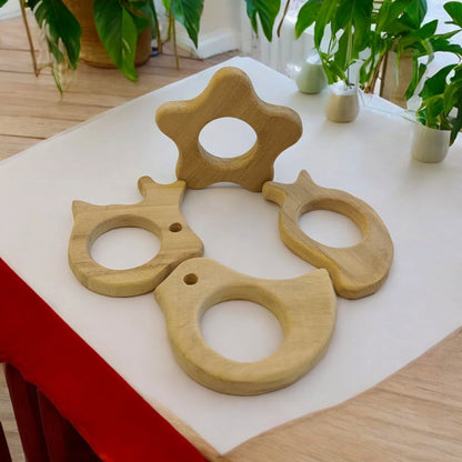 Pack of 4 Neem Wooden Teethers - Rabbit, Flower, Dove & Mango Shapes – Baby Teethers & Soothers on Brown Living™. SKU: T_RBT-FLR-DV-MNG. Img 3.