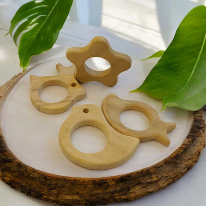 Pack of 4 Neem Wooden Teethers - Rabbit, Flower, Dove & Mango Shapes – Baby Teethers & Soothers on Brown Living™. SKU: T_RBT-FLR-DV-MNG. Img 4.