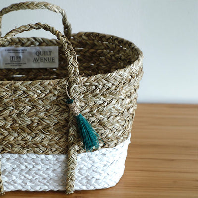 Seagrass Anthro Tassel Basket Green – Handwoven Eco Storage Basket – Home Decor on Brown Living™. SKU: AnthroTasselBasketGreenWhiteSmall. Img 4.