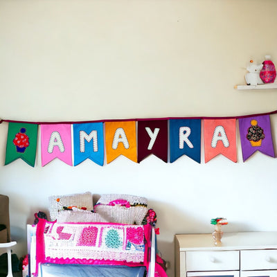 Personalized Name Bunting (Swallowtail Flag) – Wall Decor on Brown Living™. SKU: UMW - BUNTING - PRSN - ST - 01. Img 1.
