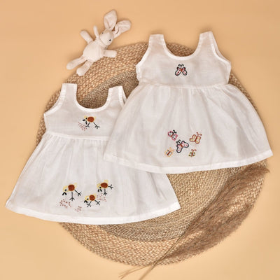 White Pure Mulmul Hand Embroidered Baby Dress Combo-Set of 2 by Stotra Brown Living White Pure Mulmul Hand Embroidered Baby Dress Combo-Set of 2 by Stotra Brown Living