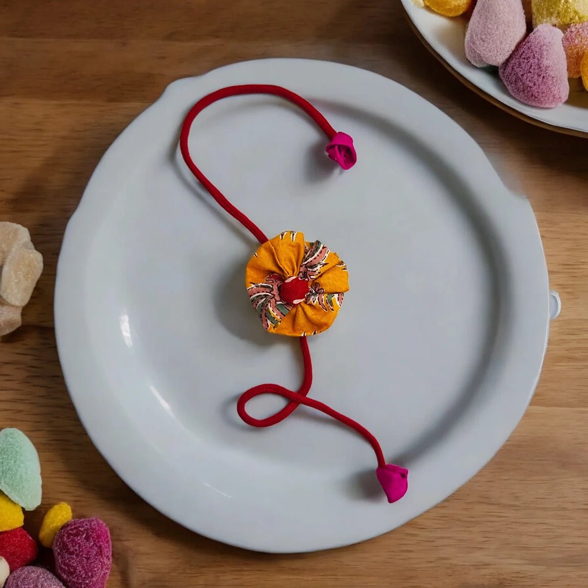 Upcycled Handmade Coral Love Rakhi – Rakhi by USE ME WORKS available on Brown Living™. . SKU: UMW - Rakhi - 08. Img 1.