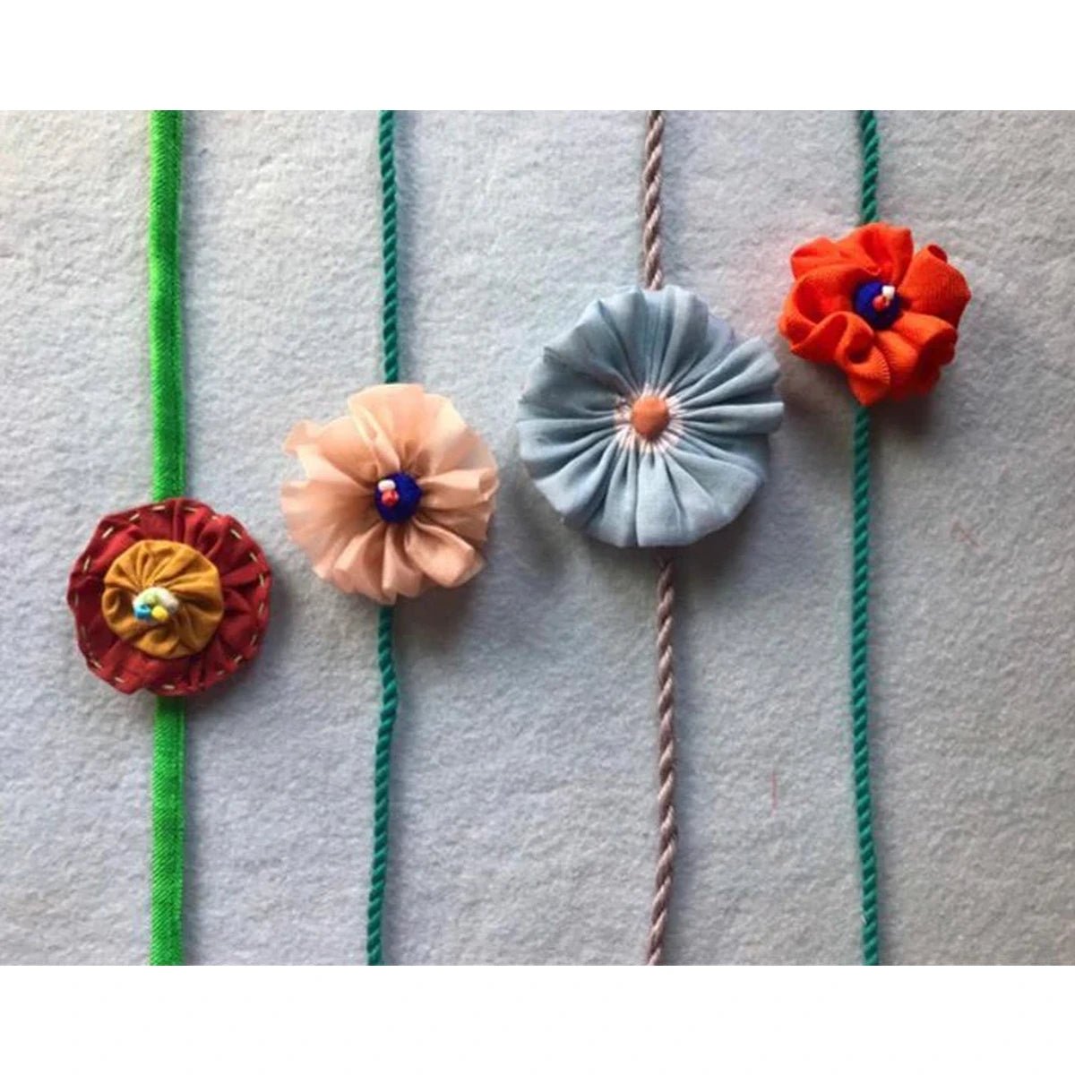 Upcycled Handmade Flower Power Rakhi Combo (Pack of 4) – Rakhi by USE ME WORKS available on Brown Living™. . SKU: UMW - Combo - Rakhi - 06. Img 3.