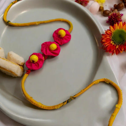 Upcycled Handmade Pink Sunbird Rakhi – Rakhi by USE ME WORKS available on Brown Living™. . SKU: UMW - Rakhi - 12. Img 1.
