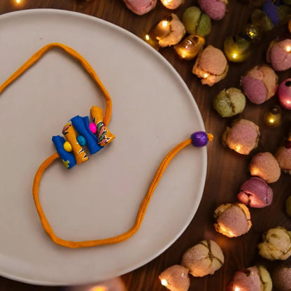 Upcycled Handmade Rolymoly Rakhi – Rakhi by USE ME WORKS available on Brown Living™. . SKU: UMW - Rakhi - 09. Img 1.