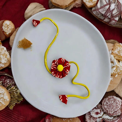 Upcycled Handmade Scarlet Daisy Rakhi – Rakhi by USE ME WORKS available on Brown Living™. . SKU: UMW - Rakhi - 01. Img 1.