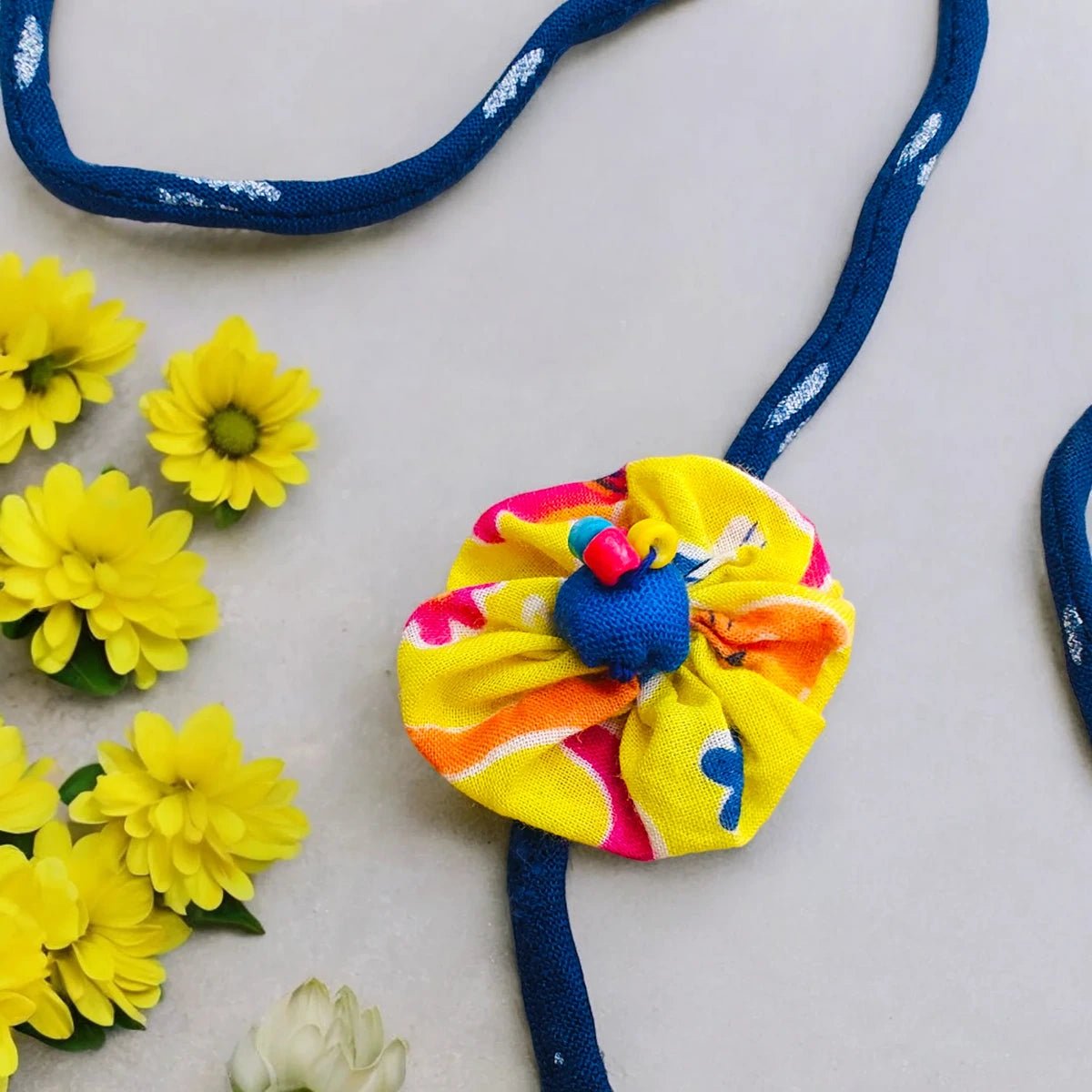 Upcycled Handmade Sunflower Rakhi – Rakhi by USE ME WORKS available on Brown Living™. . SKU: UMW - Rakhi - 06. Img 1.