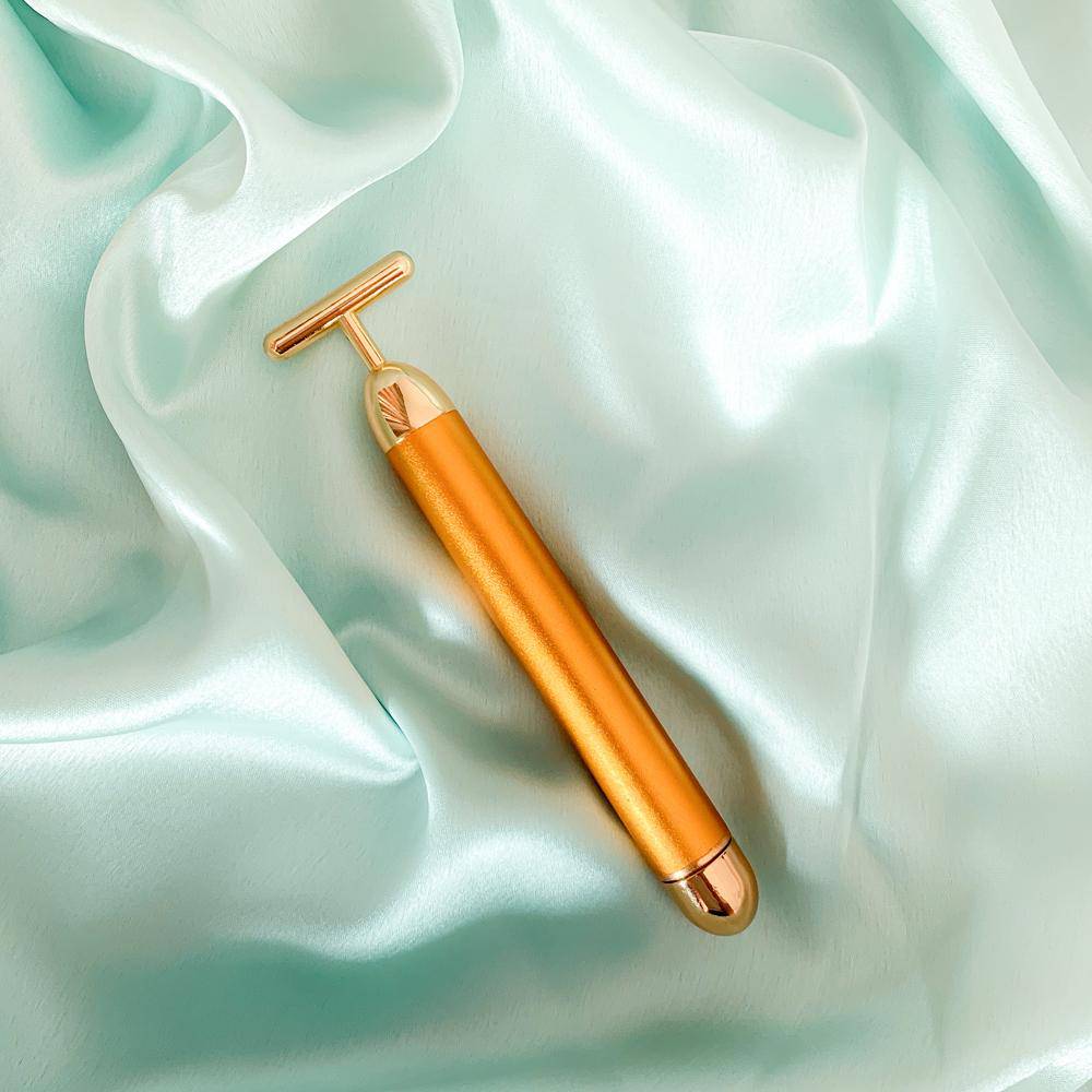 24k Gold Vibrating Face Roller & Sculptor | FREE Gold Beauty Elixir Oil – Massager by Natural Vibes available on Brown Living™. . SKU: 063 - 13171 - NV_gold_roller_oil. Img 1.